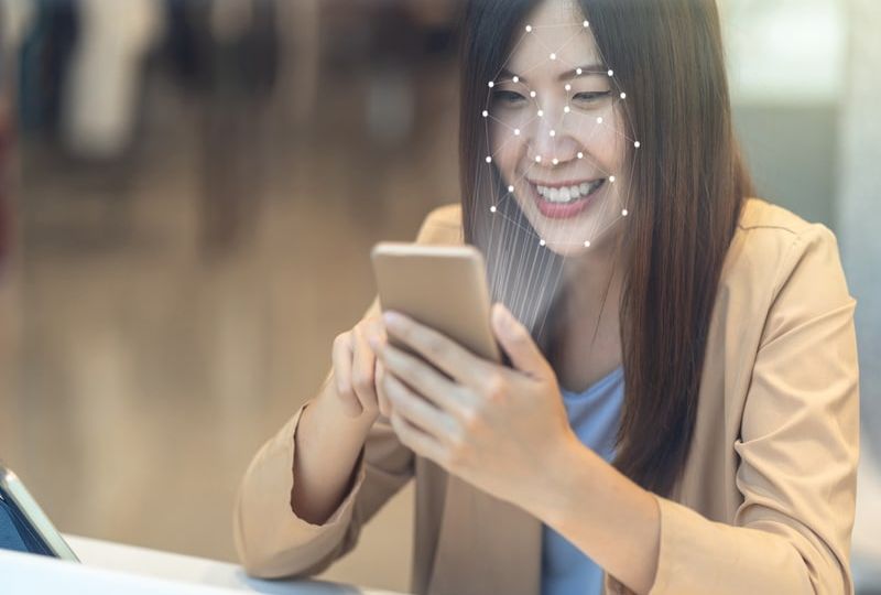 Asian women using the technology tablet for access control by face recognition