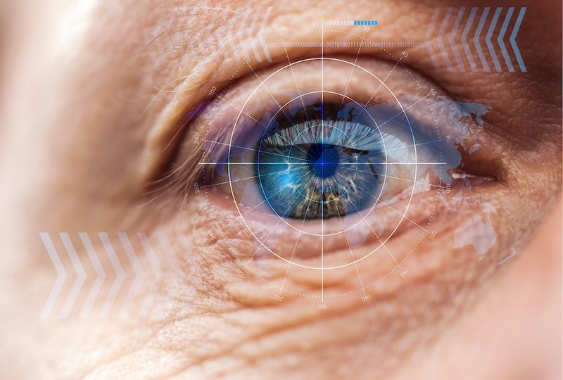 close up view of mature human eye with data illustration, robotic concept